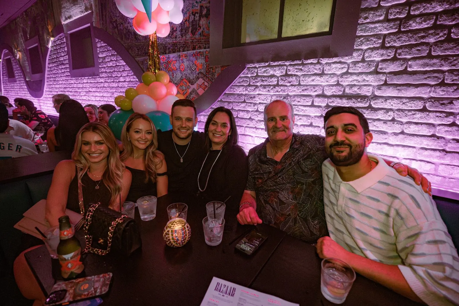 A birthday group celebrating in a Bazaar booth