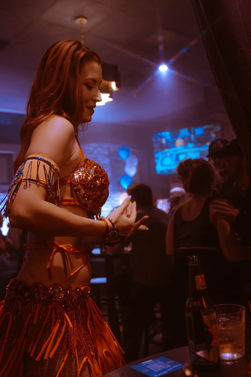 A belly dancer performing between the tables